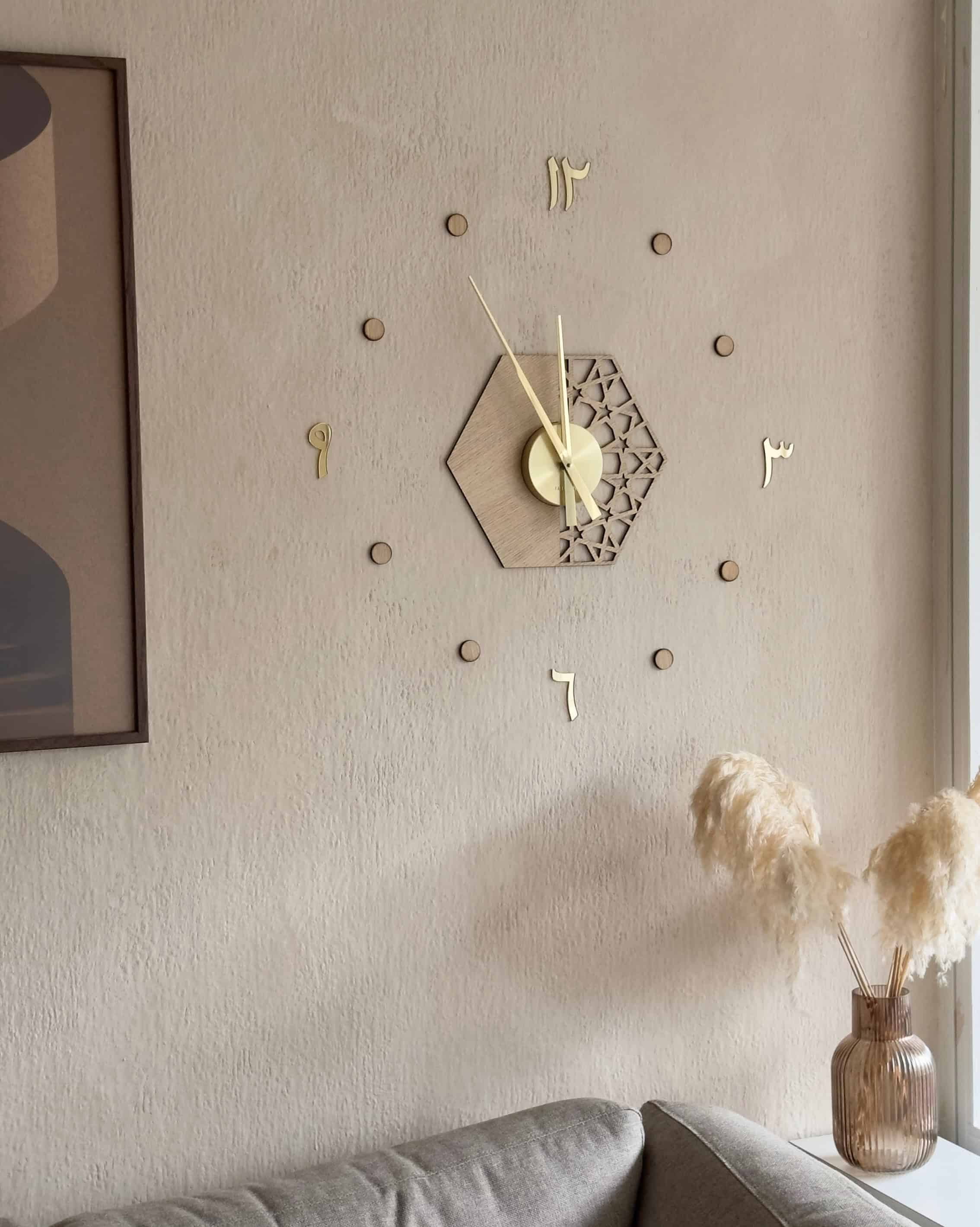 dekorativt vægur med islamisk inspireret design i guldfarvet, eg